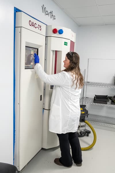 EyeKraft lab technician operating coating chamber