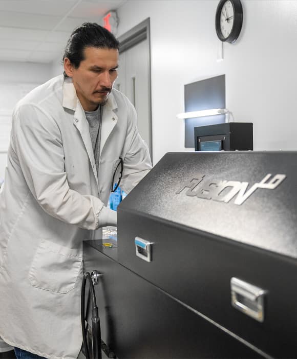 A technician at work in the EyeKraft lab