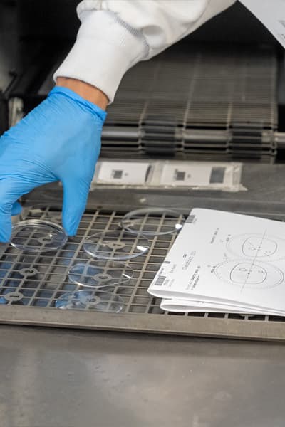 Quality assurance team member inspecting lenses
