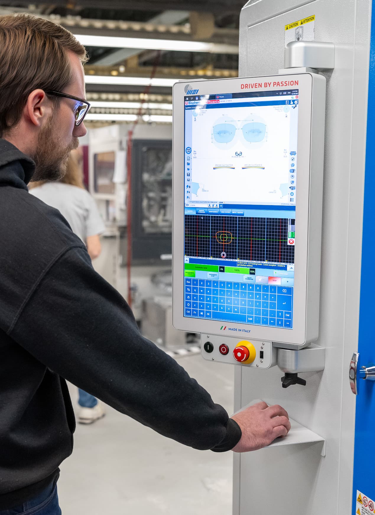 EyeKraft technician operating digital lens edging equipment