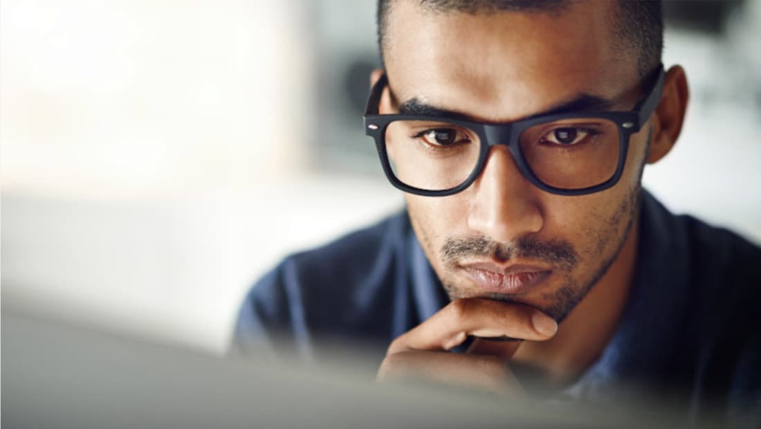A man in clear glasses with an anti-reflective coating